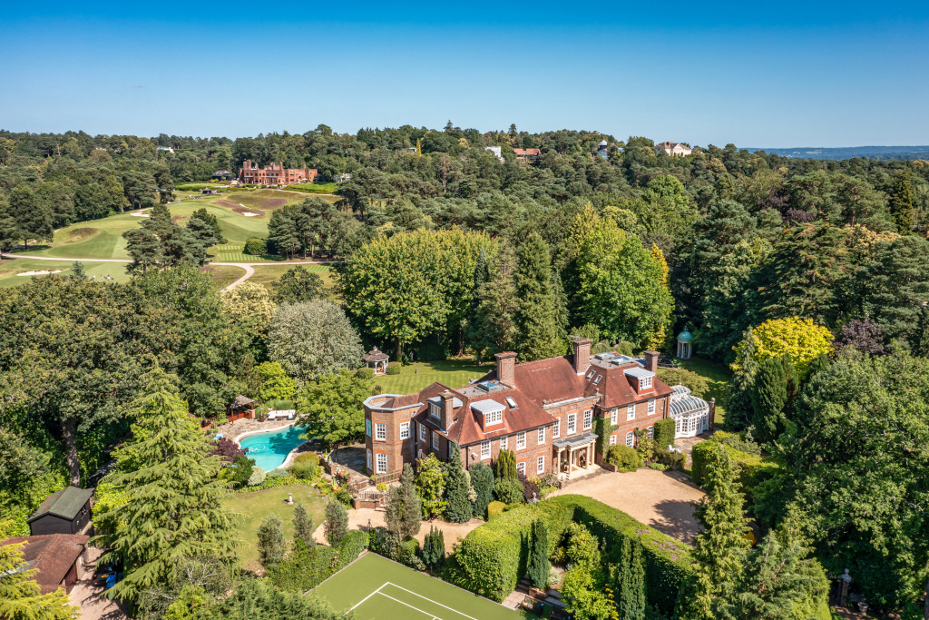 aerial view of St George's Hill surrey property with house and pool surrounded by greenery