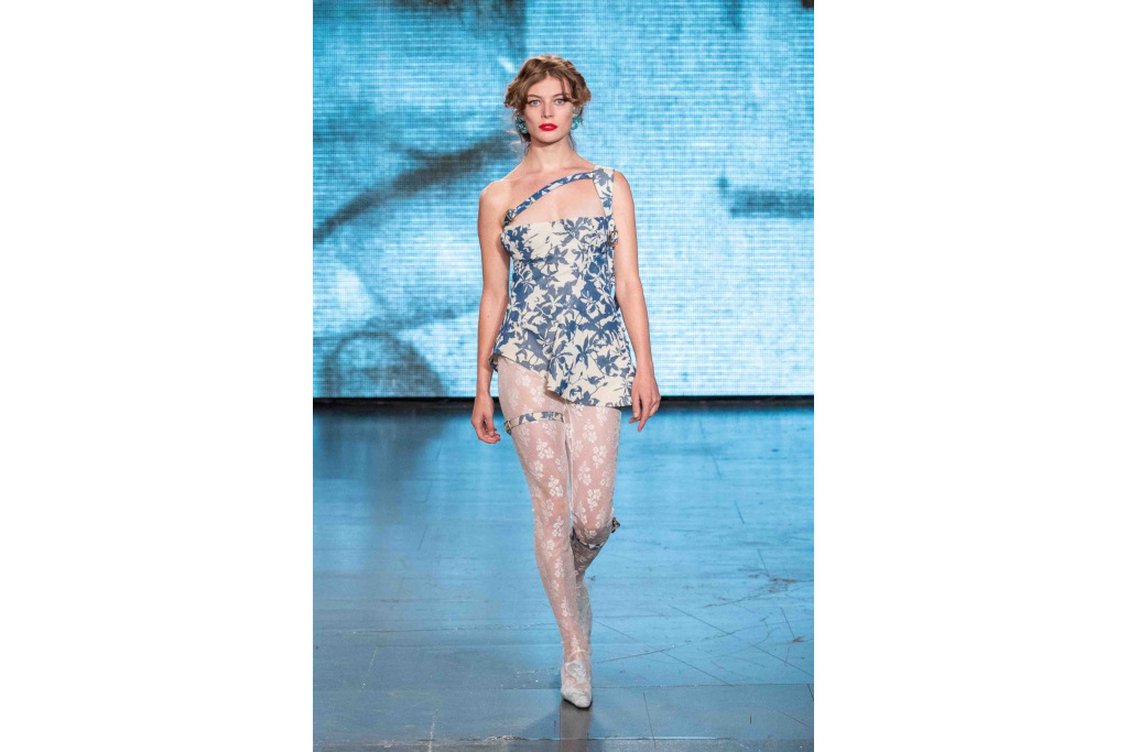 Model in blue and white patterned corset mini dress and white tights