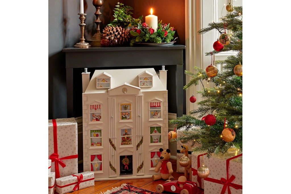 Advent calendar shaped like house by Christmas tree