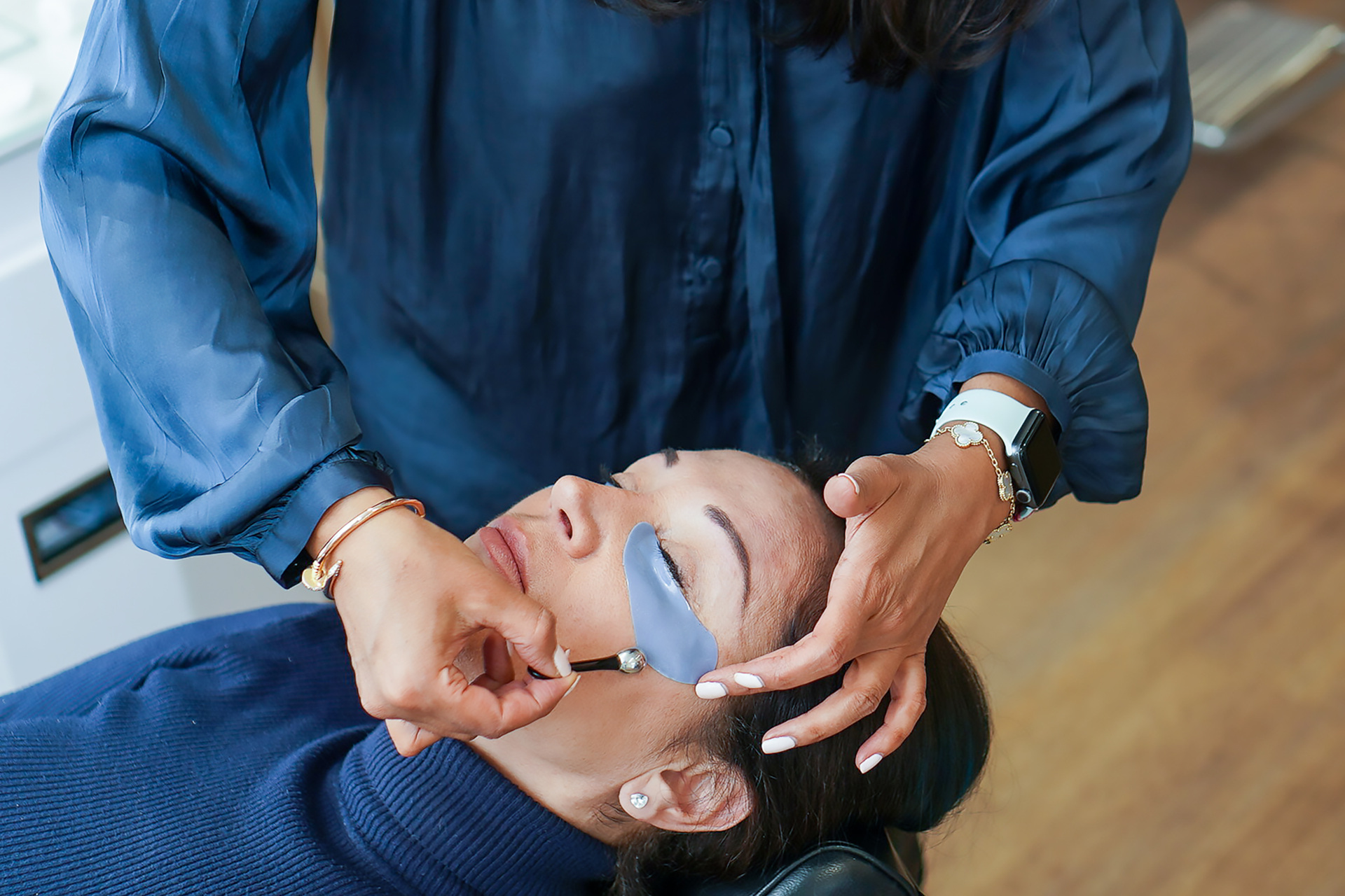Woman receiving facial treatment