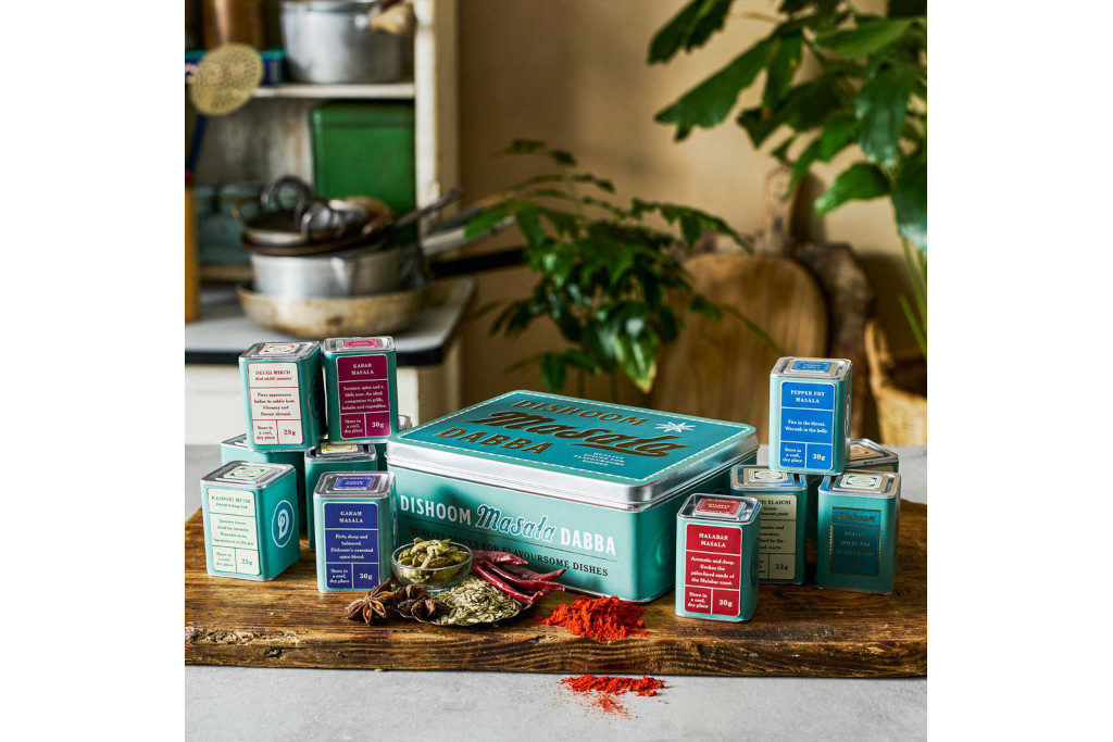 Tins and boxes on wooden board in kitchen