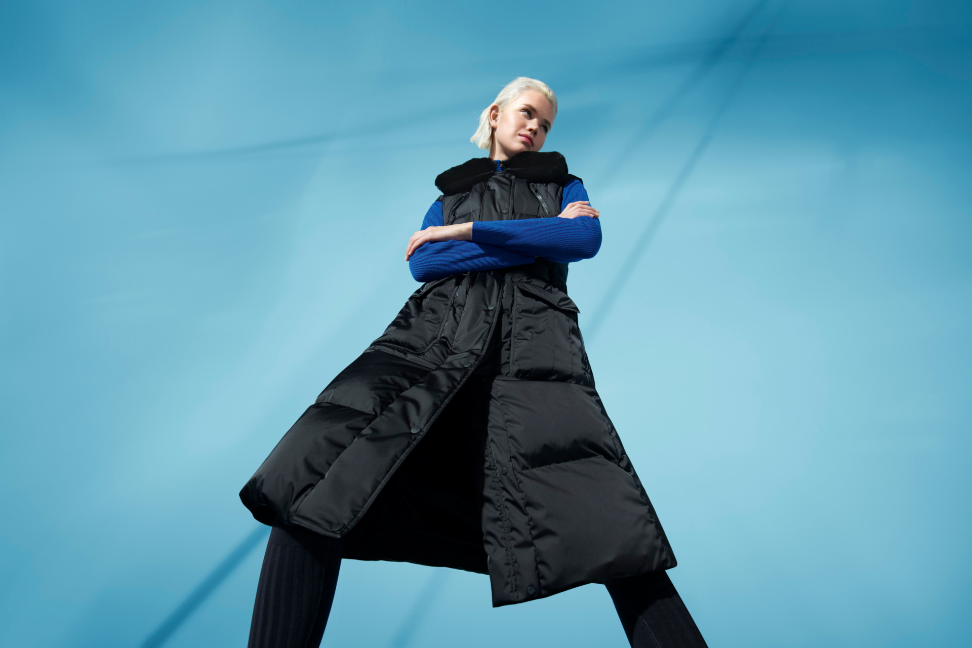 Model in long puffer jacket looking down