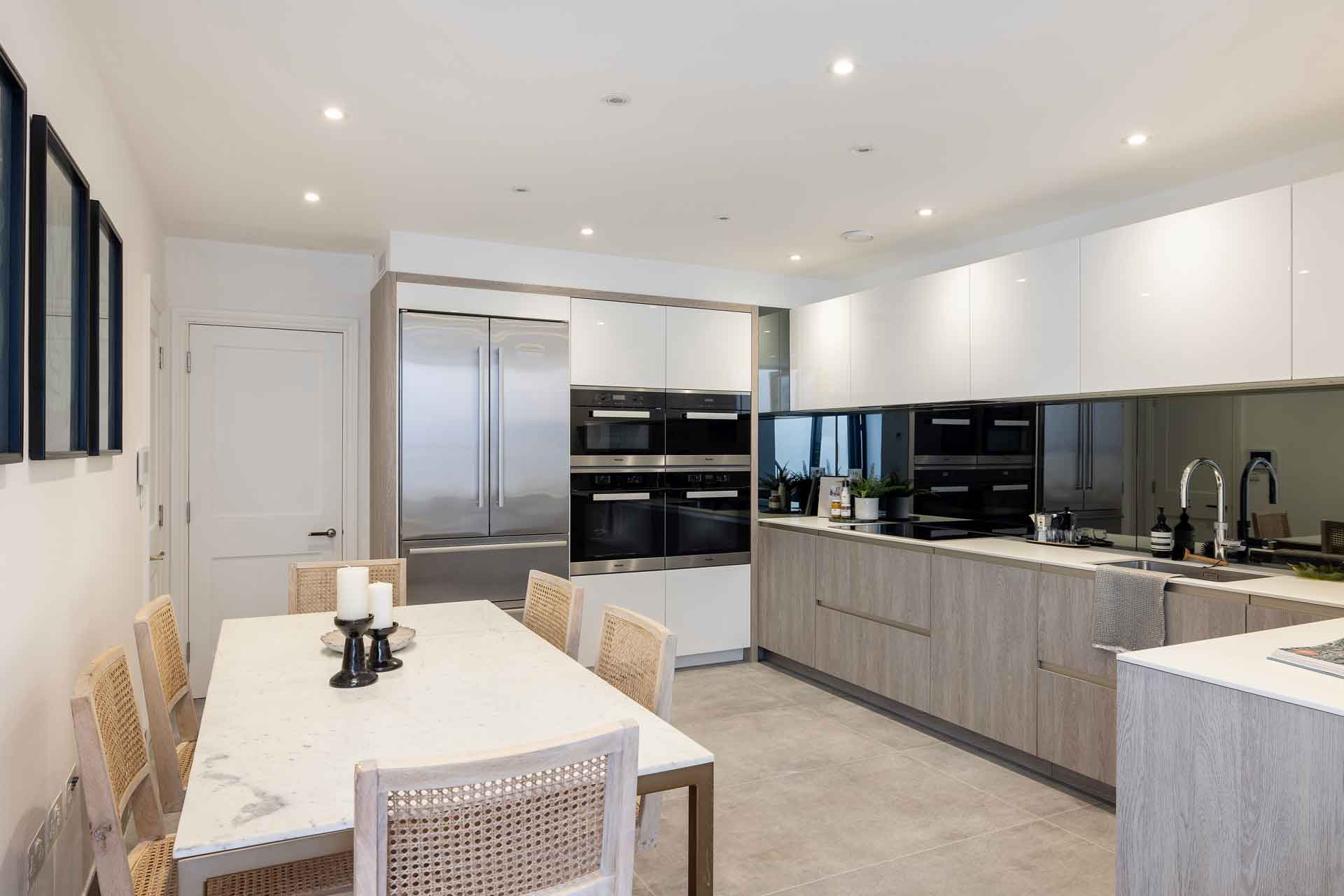 Modern kitchen with brushed wooden cabinets and white countertops