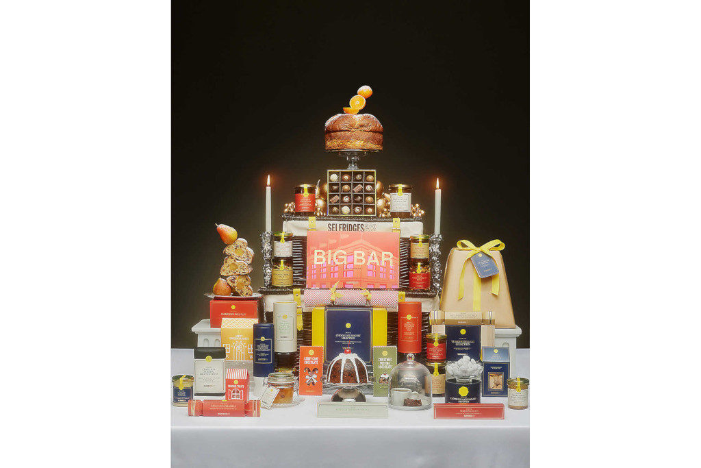 Christmas cakes, treats and drinks around wicker hamper