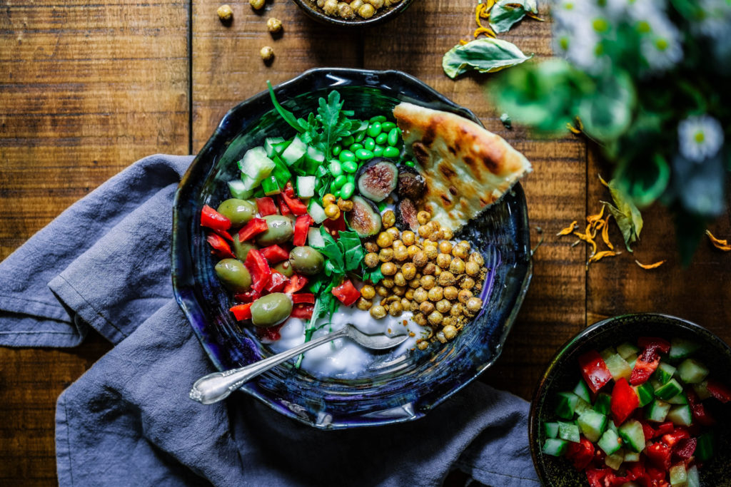 Bowl of vegetables, beans, chickpeas and lentils with a silver spoon (healthy meal delivery services)