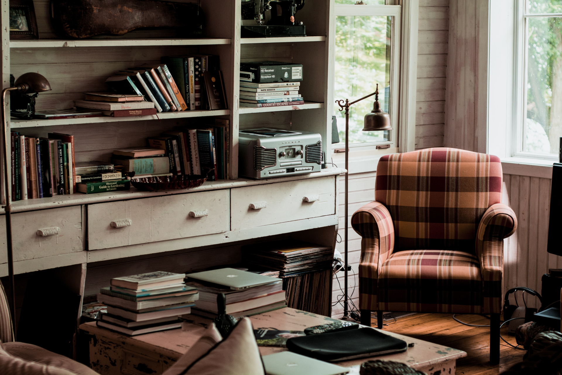 Sitting room with armchair and full bookshelf