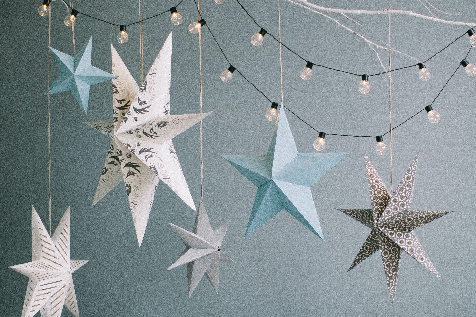 Paper stars hung up with fairy lights