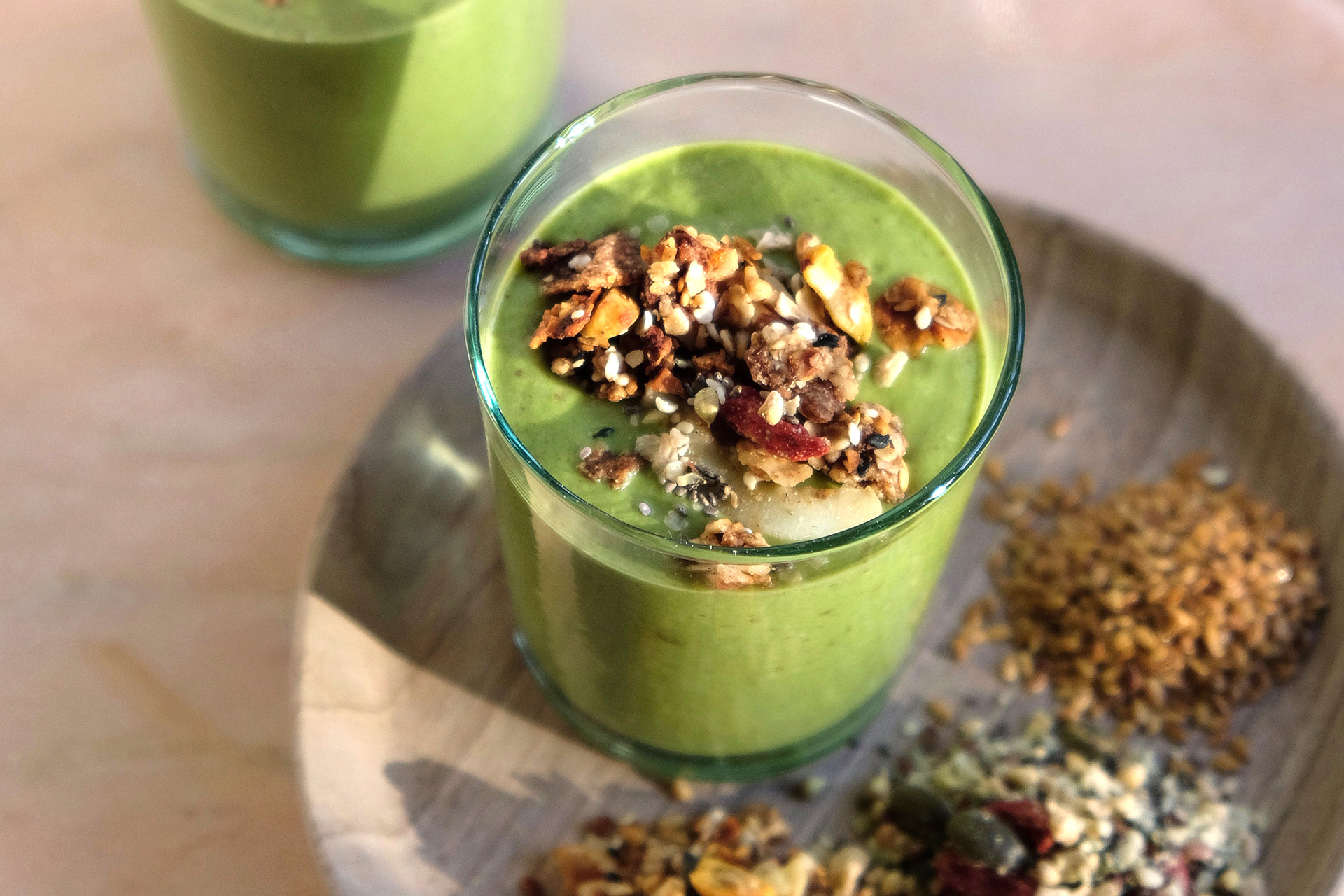 Wild By Tart's Ultimate Breakfast Smoothie - green smoothie in a glass surrounded by seeds