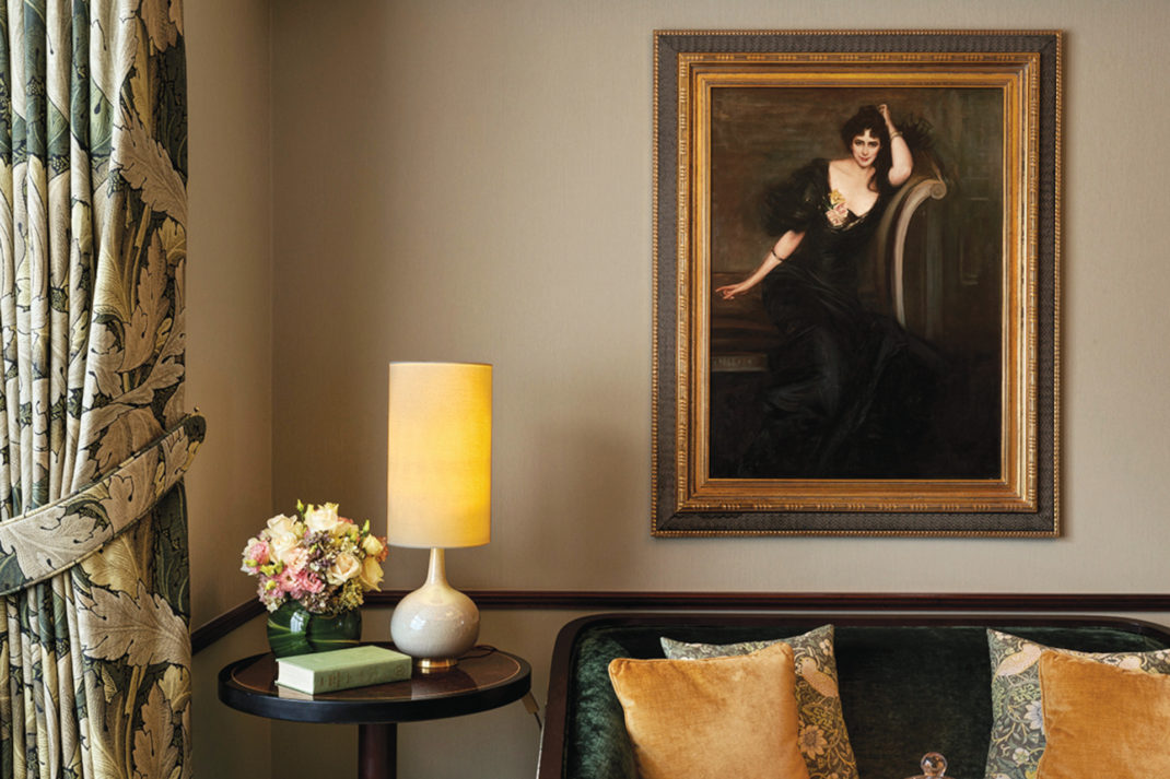 Room with painting, side table and lamp, and sofa