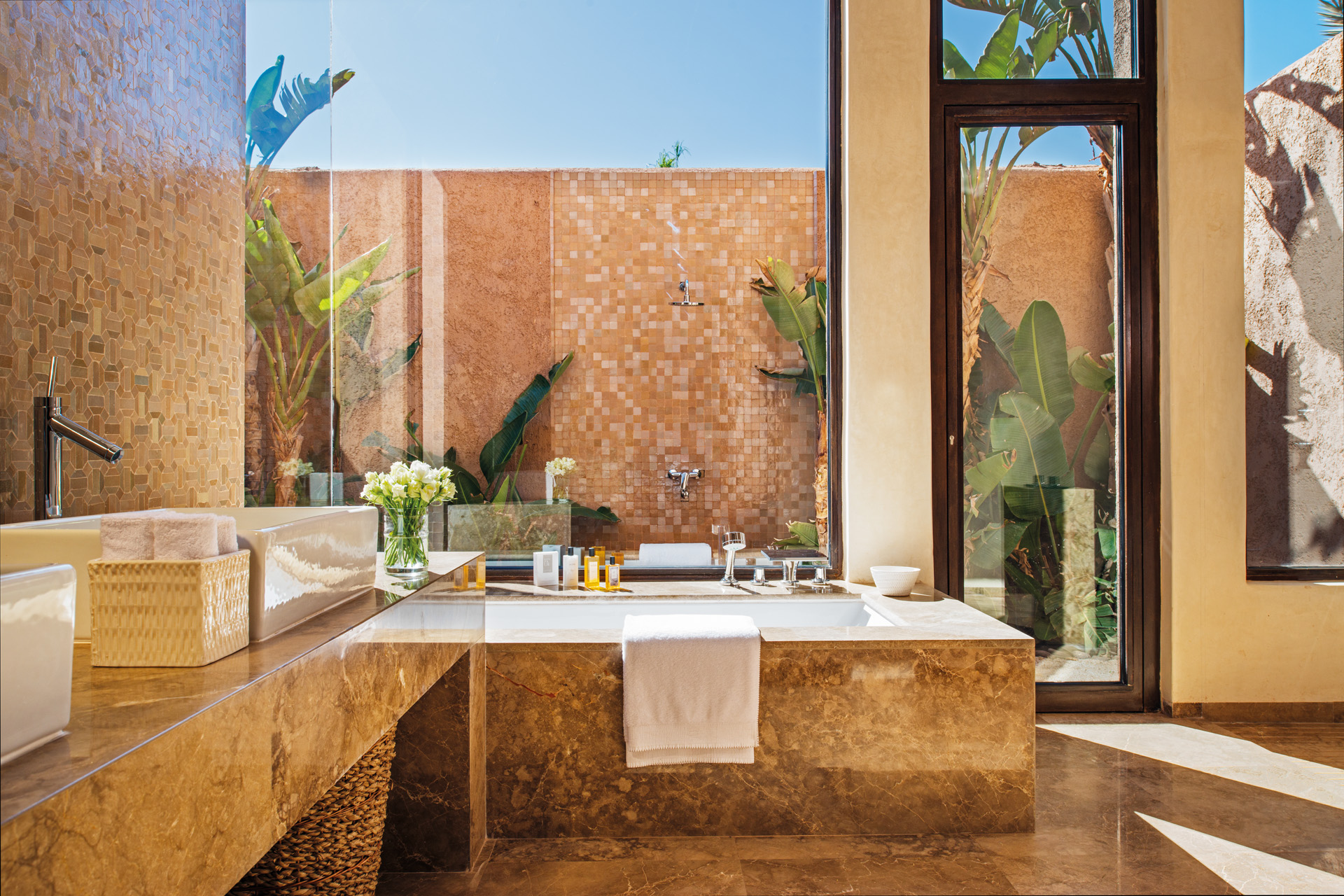 an outdoor, pink tiled bathroom