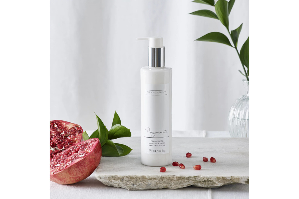 Hand cream on table with pomegranates