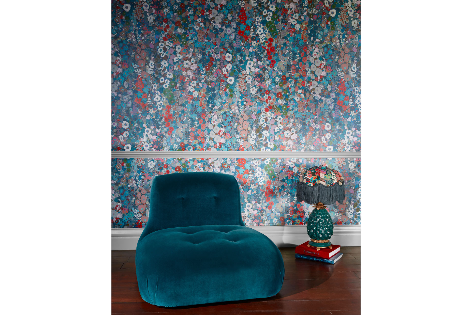 The Hollyhocks Wallpaper from the House of Hackney with a blue sofa and chintzy lamp