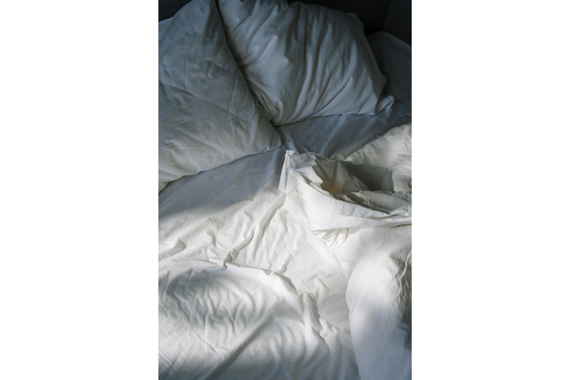 A bed with ruffled duvet