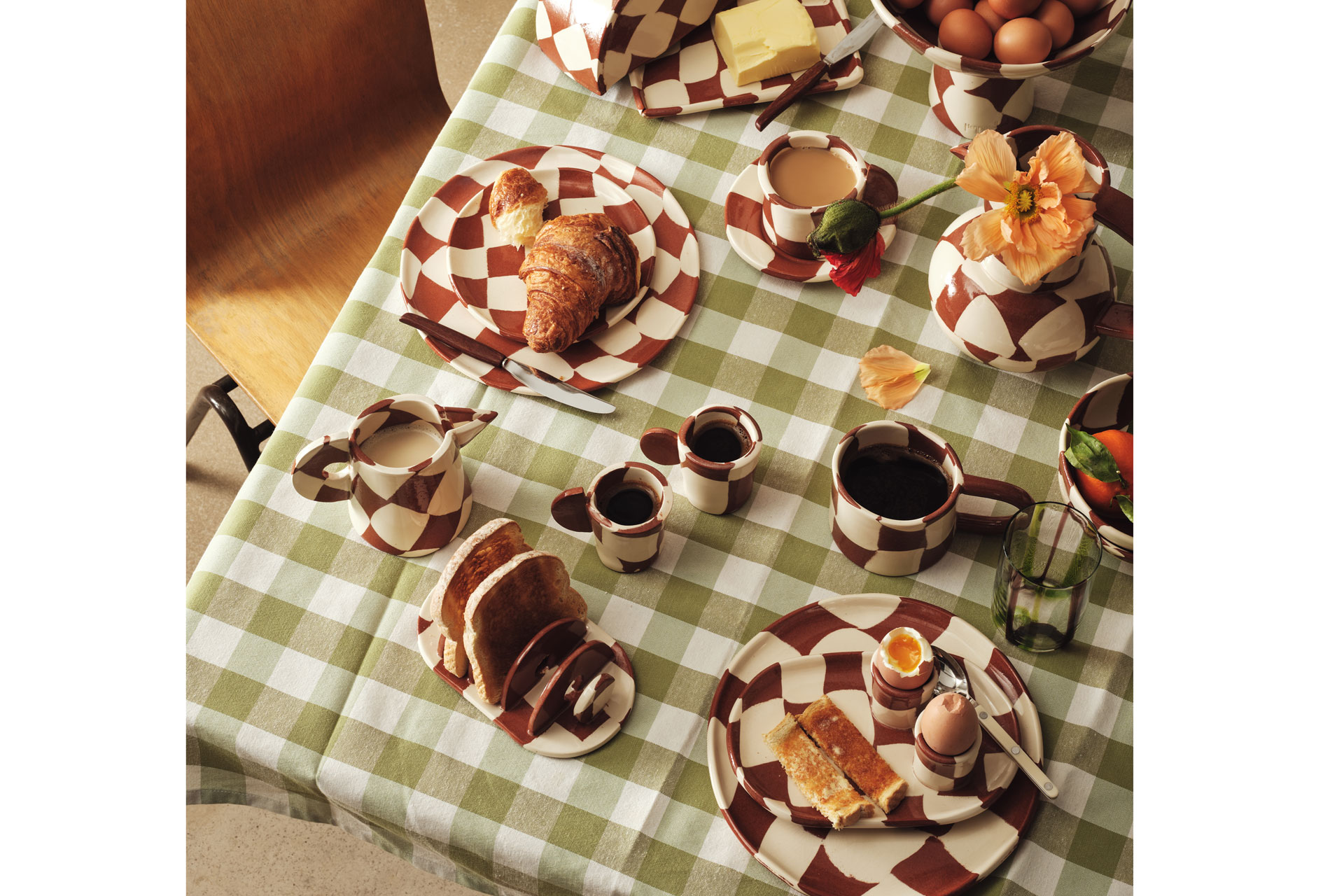 white and red checkered pottery sits on a light green gingham tablecloth
