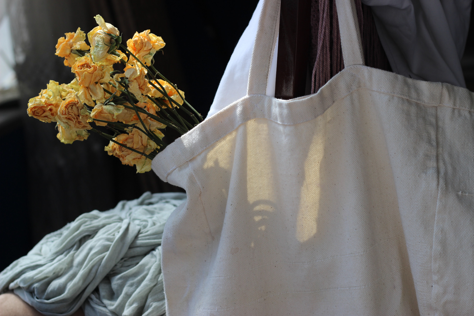 Close up of tote bag with flowers sticking out of the top