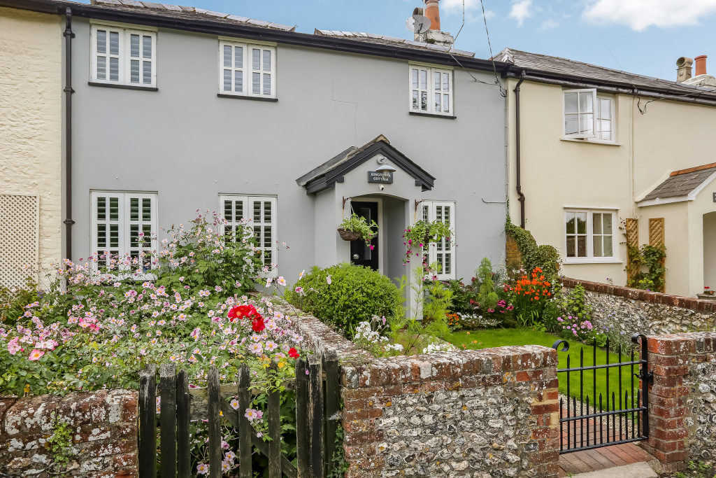 pretty grey blue country cottage with front garden and flowers