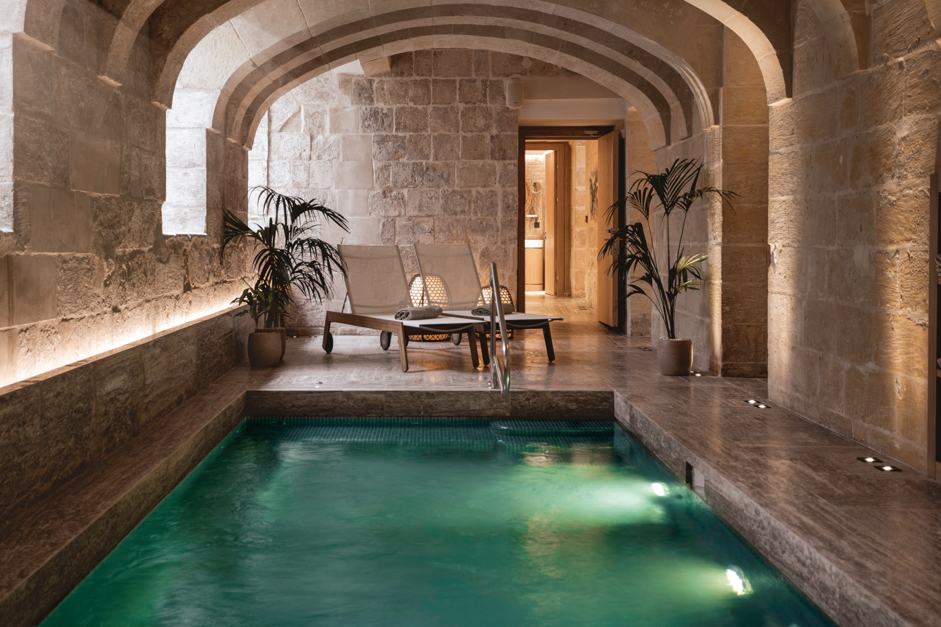 A spa pool in a brick room