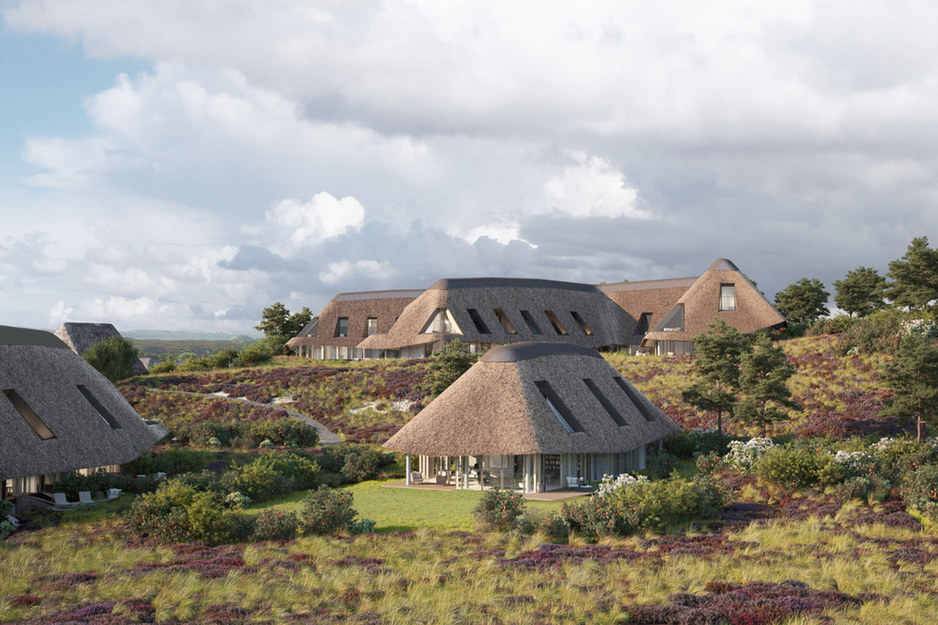 a series of thatched huts in a vegetated landscape