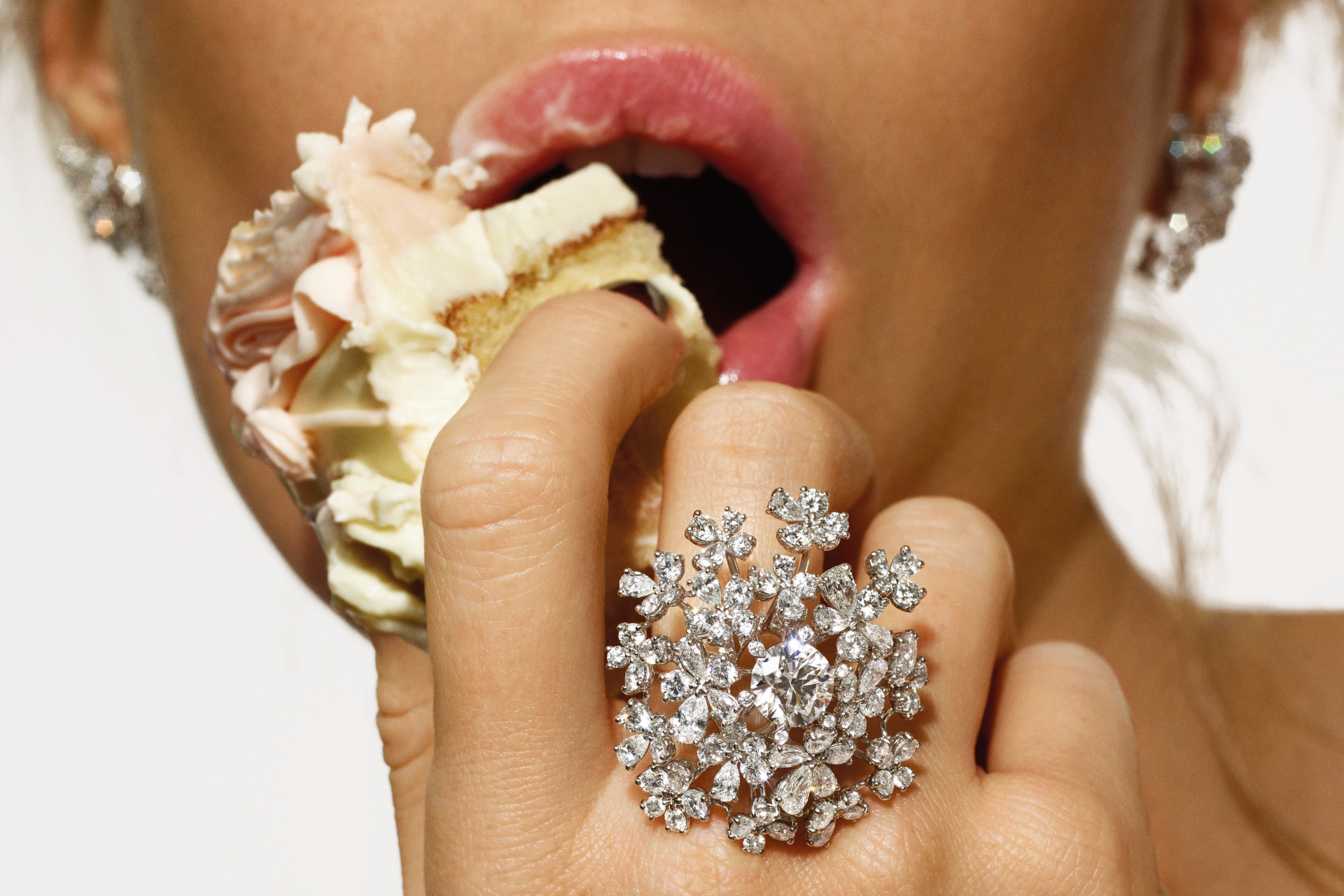 Woman eating cake with a large ring on her finger