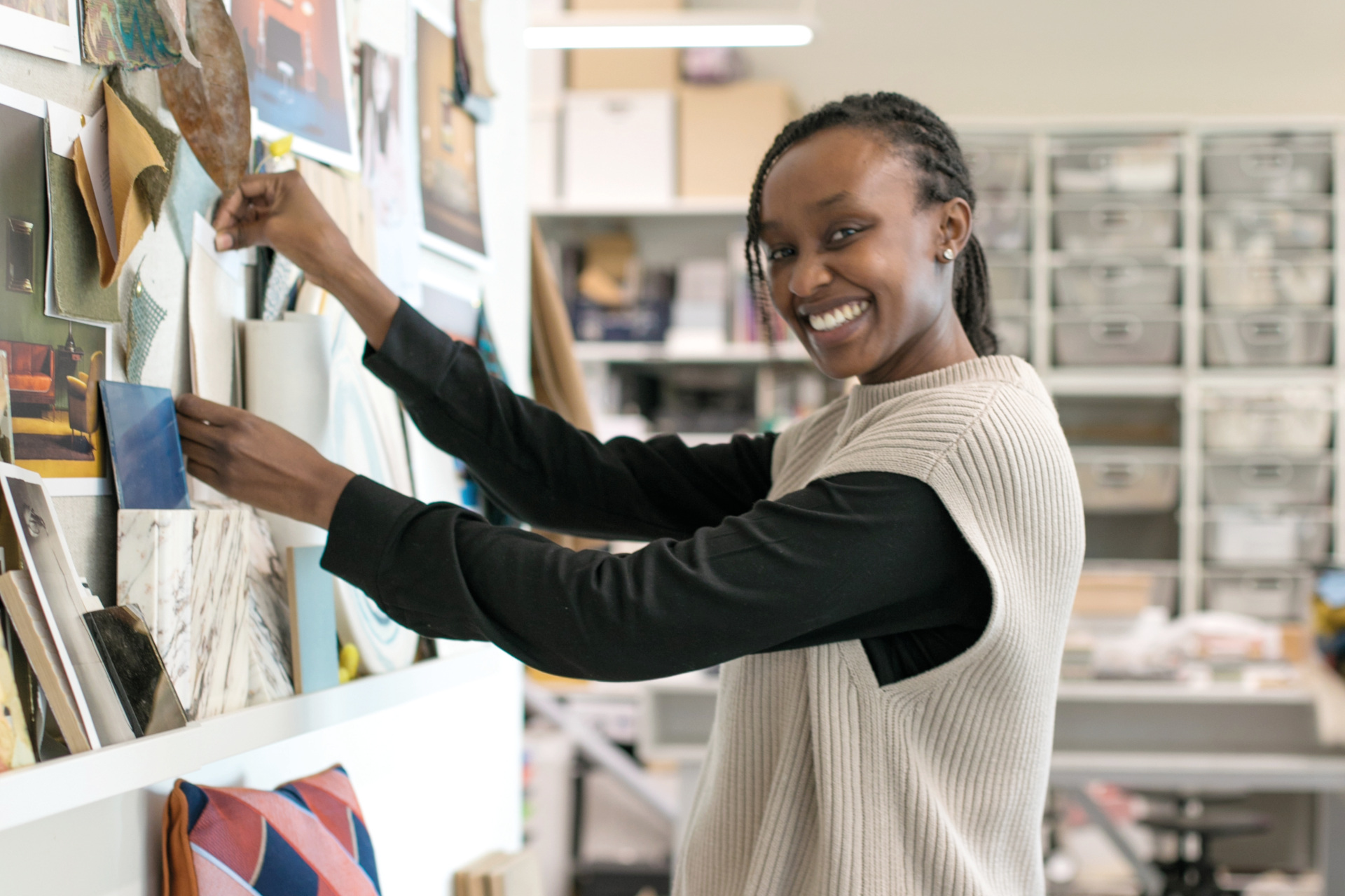 Mercy Sossion hanging artwork on the wall