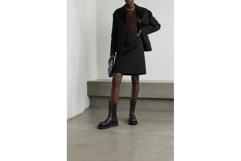 Model in black blazer and skirt