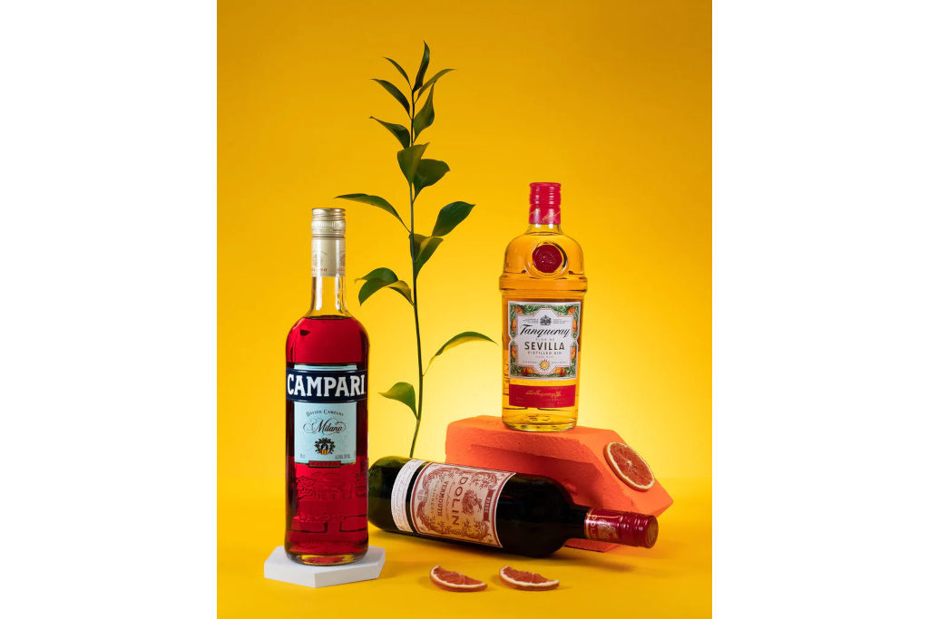 Bottles on alcohol on yellow background
