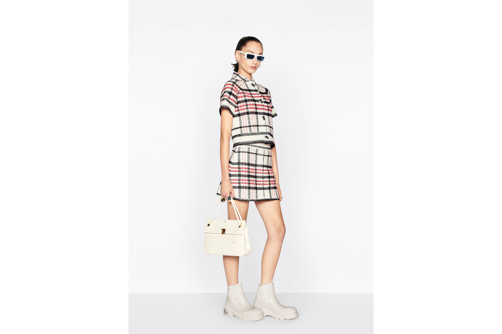 Model in tartan short-sleeve jacket and skirt