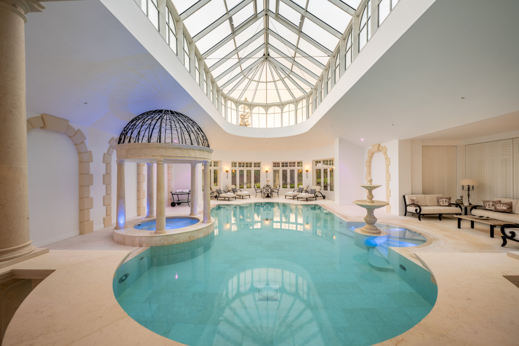 stunning luxury indoor swimming pool with glass vaulted ceiling 
