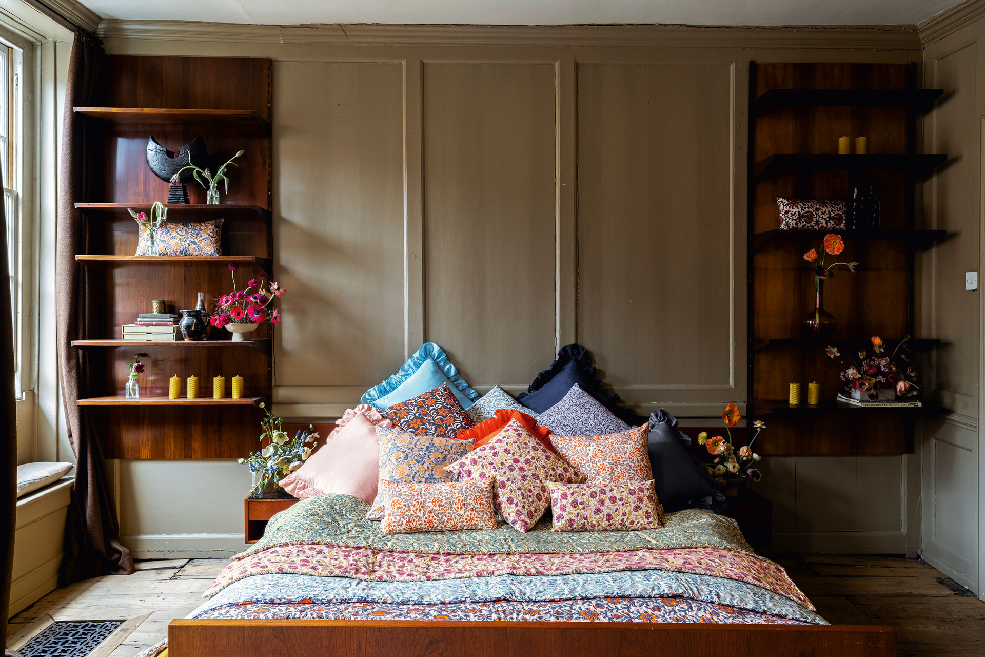 a scene of a bed covered in Chintz quilts and ruffled cushions by Daughters of Gaea