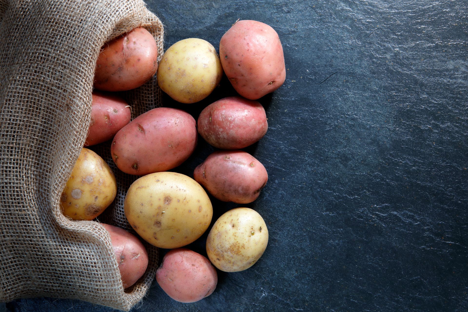 Red and Gold potatoes in hessian sack
