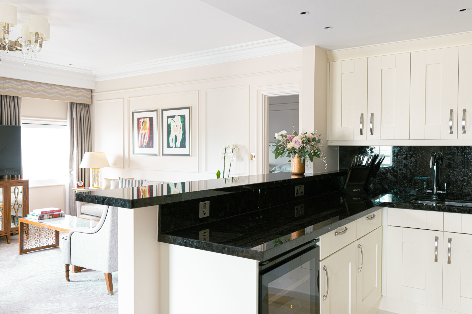 Elegant white kitchen with black counters