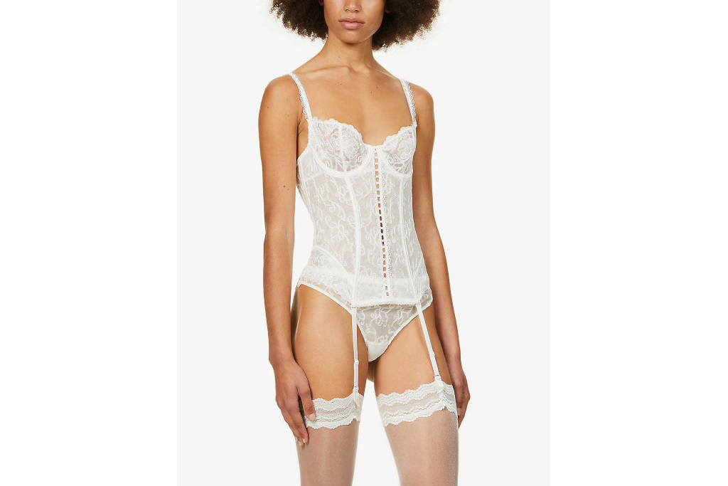 Model in white stretch-lace basque, garter belt and stockings