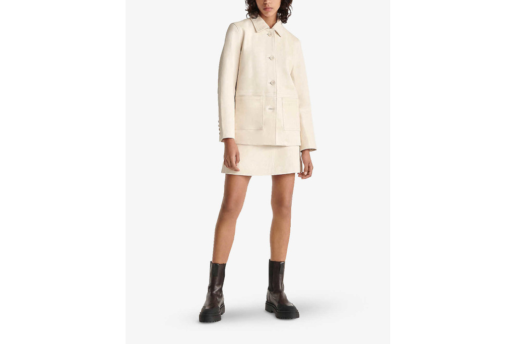 Model in cream leather jacket and skirt