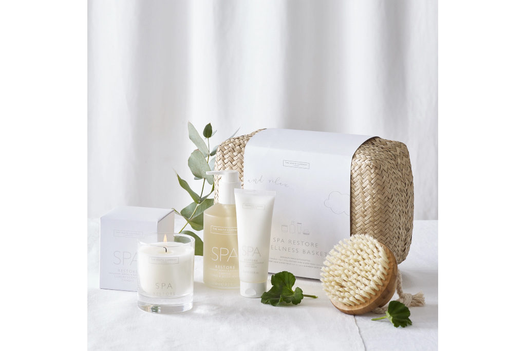 Basket with spa items on white background