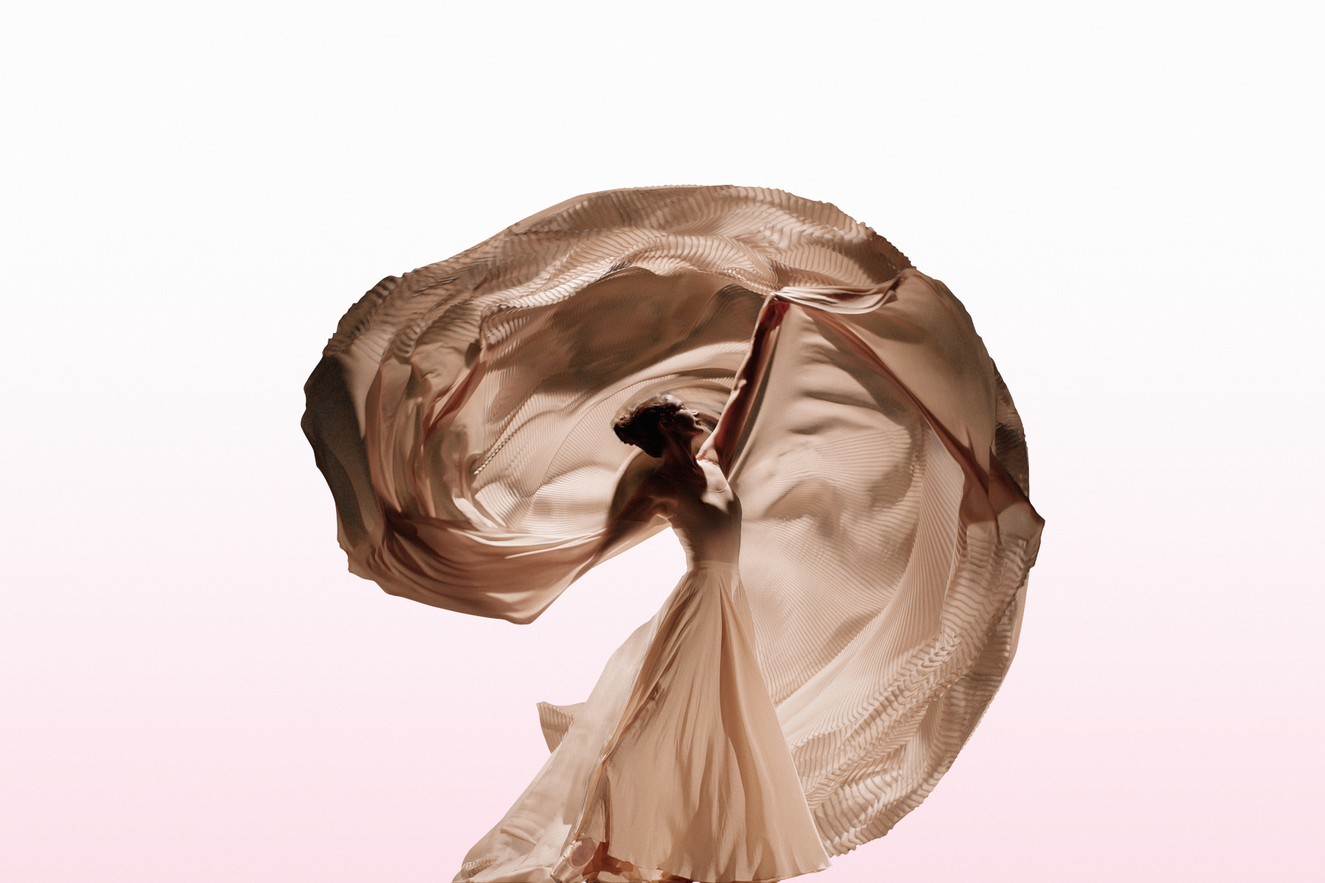 Lauren Cuthbertson pulling floaty fabric above her head in pink setting