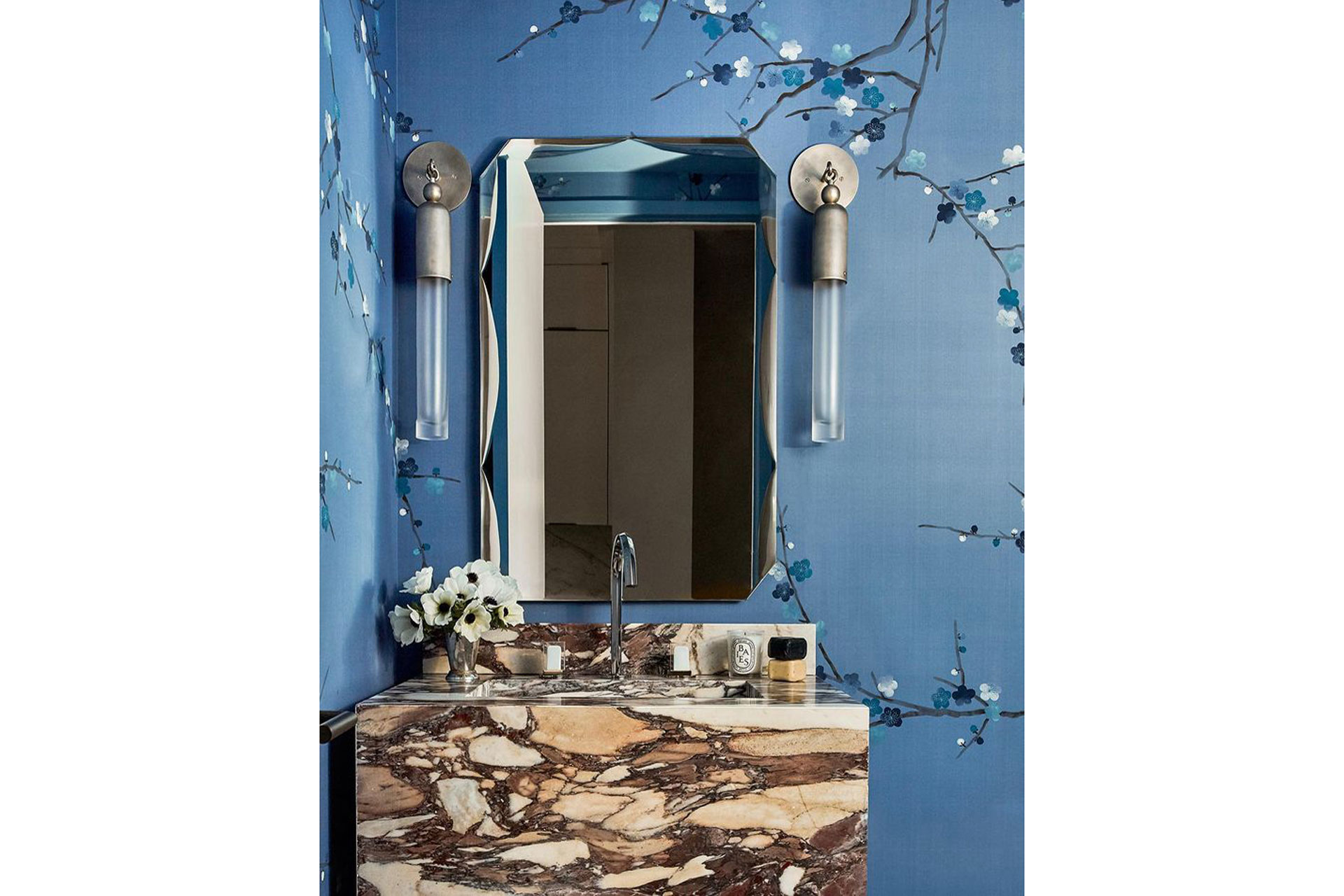 Tonal flowers of Du Gournay ‘Plum Blossom’ wallpaper, hand painted here on Sky Blue dyed silk, frame a richly swirled marble basin within a striking powder room installation by Hilary Matt