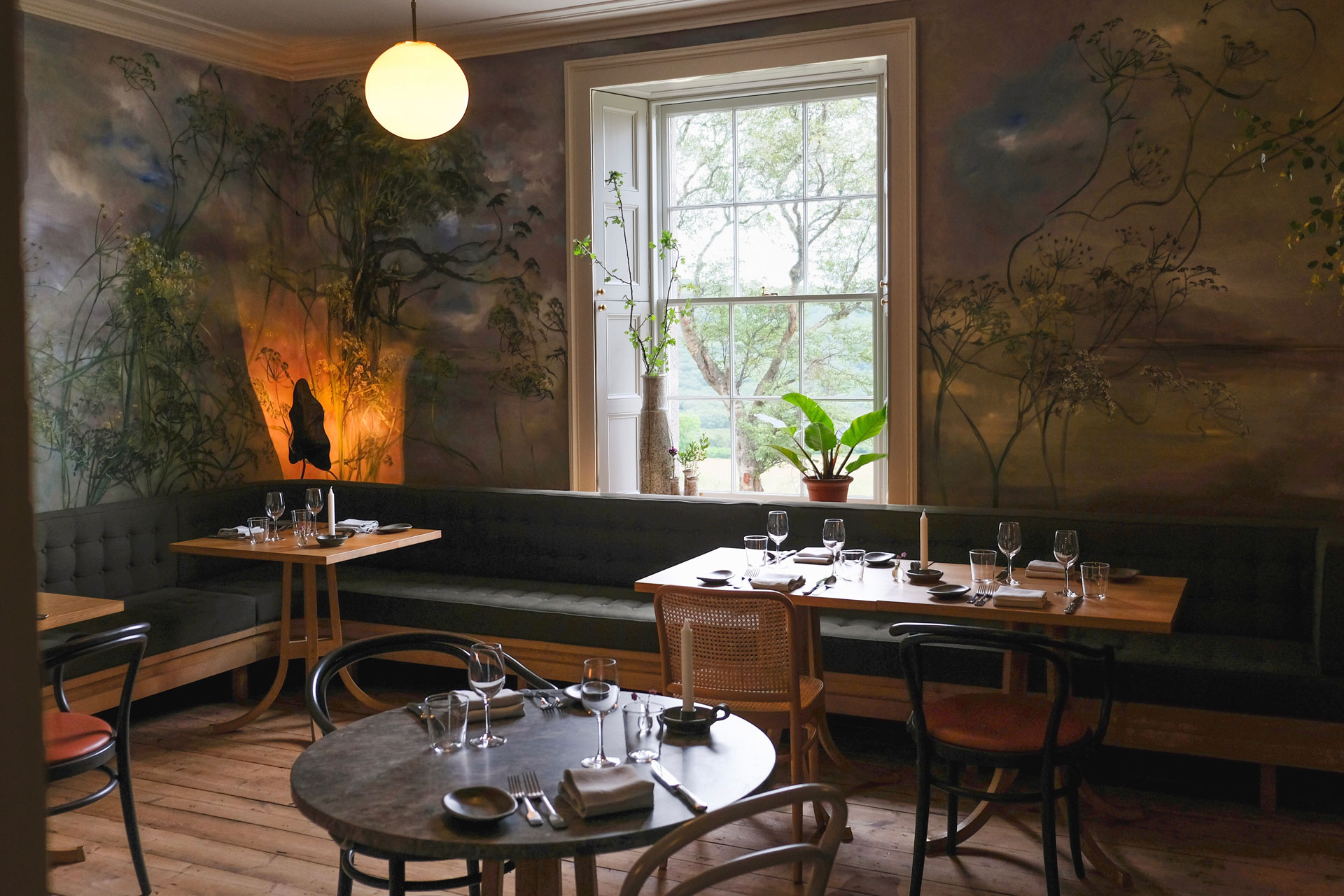 a view of the restaurant with a floral mural at Lundies House in the Scottish Highlands