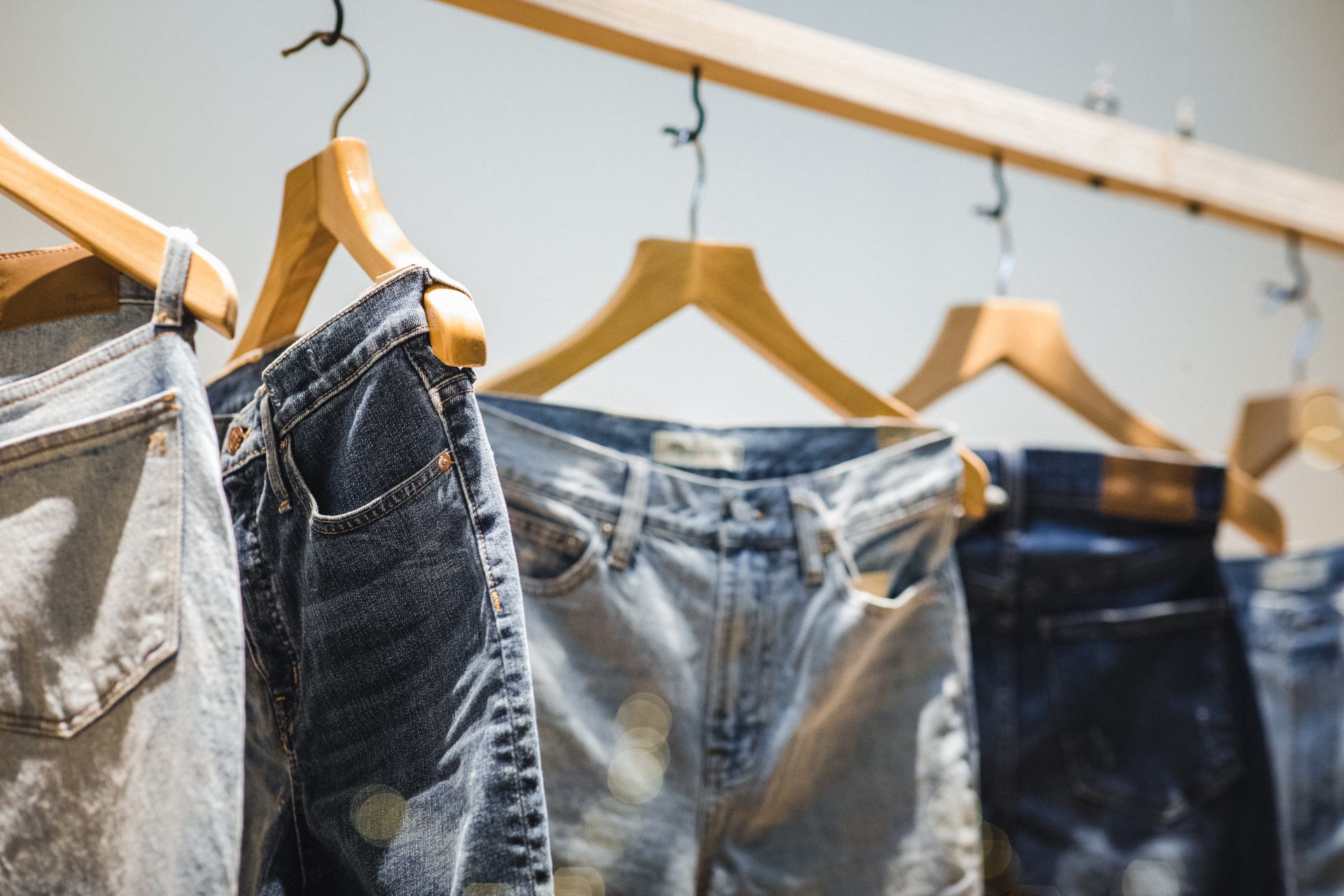 Denim jeans hanging on rail