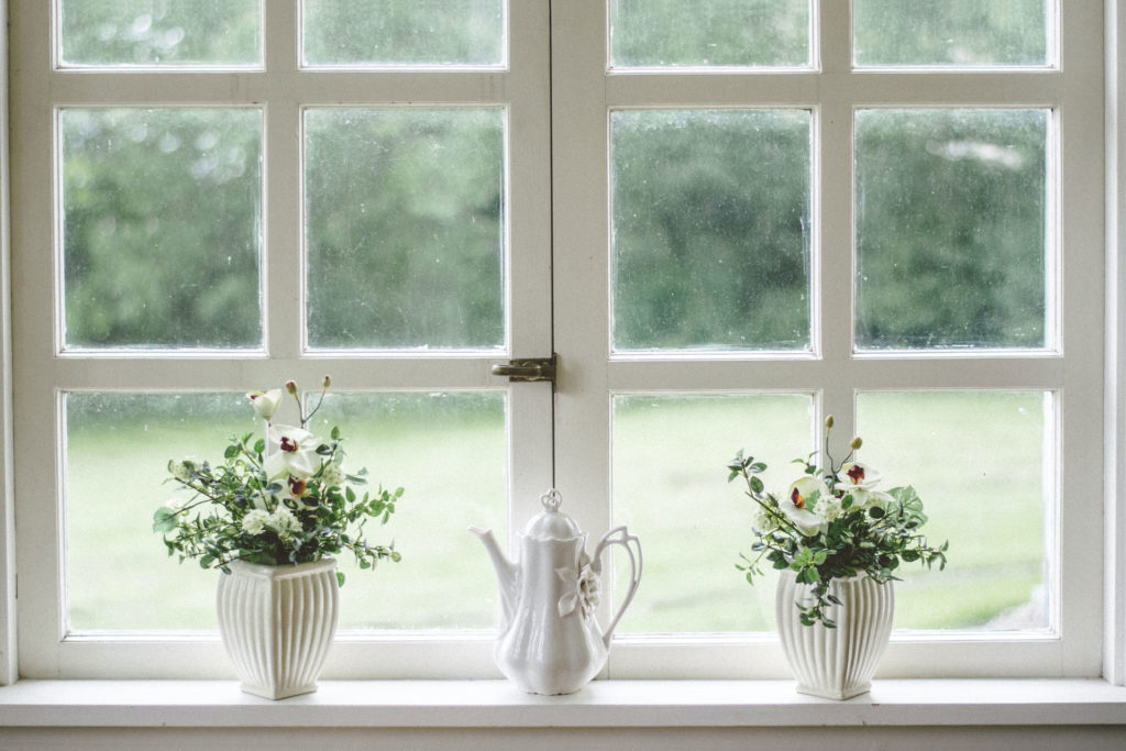 teapot and flowers on a windowsill