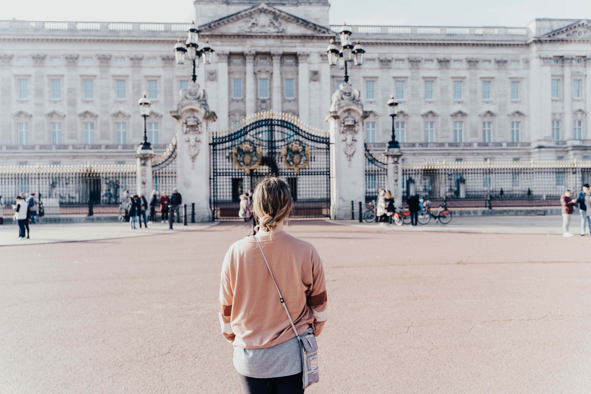 a teenager looks out to Buckingham Palace in London