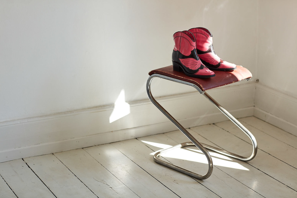 Pink cowboy boots on a chair