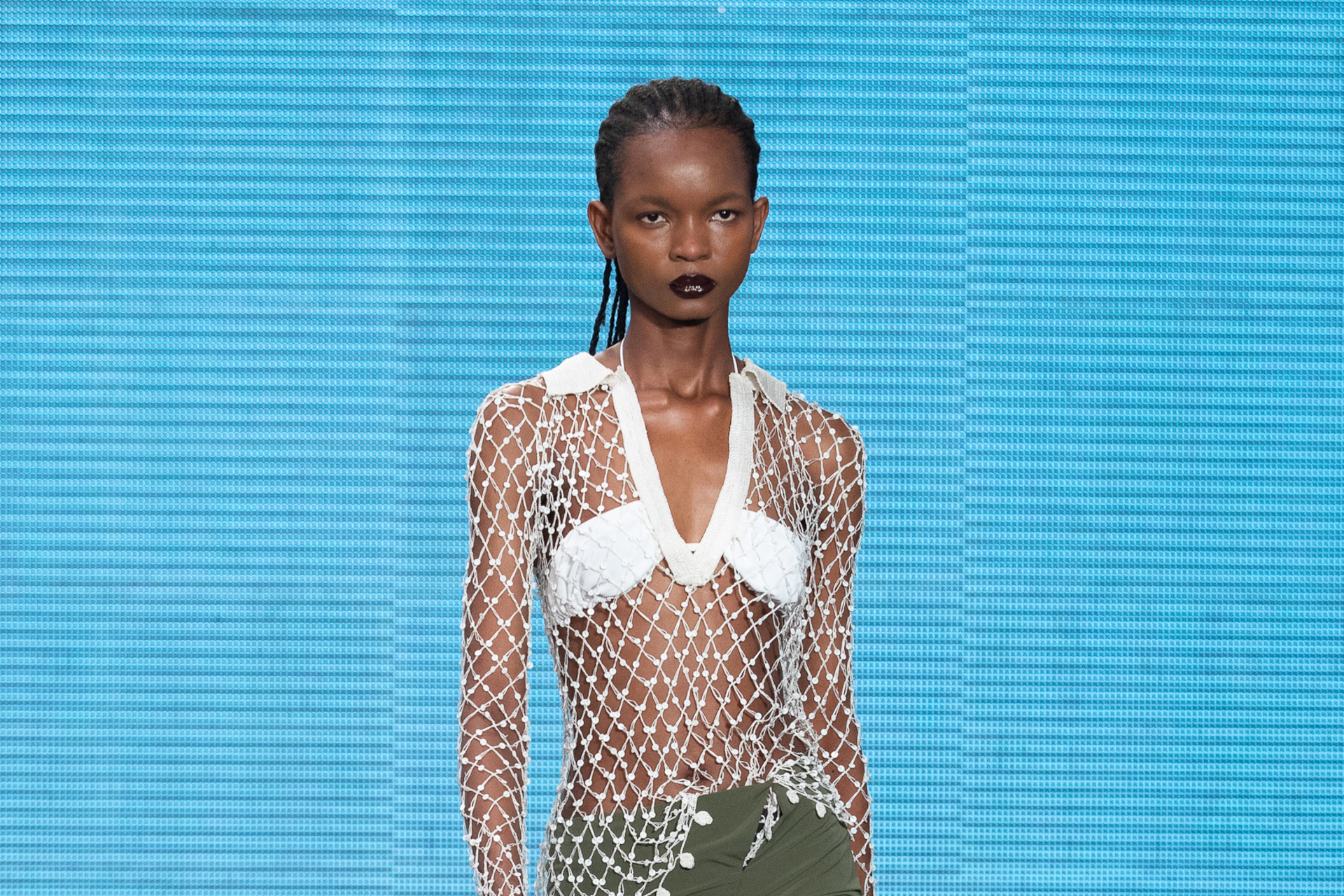 Model in white bandeau and net top