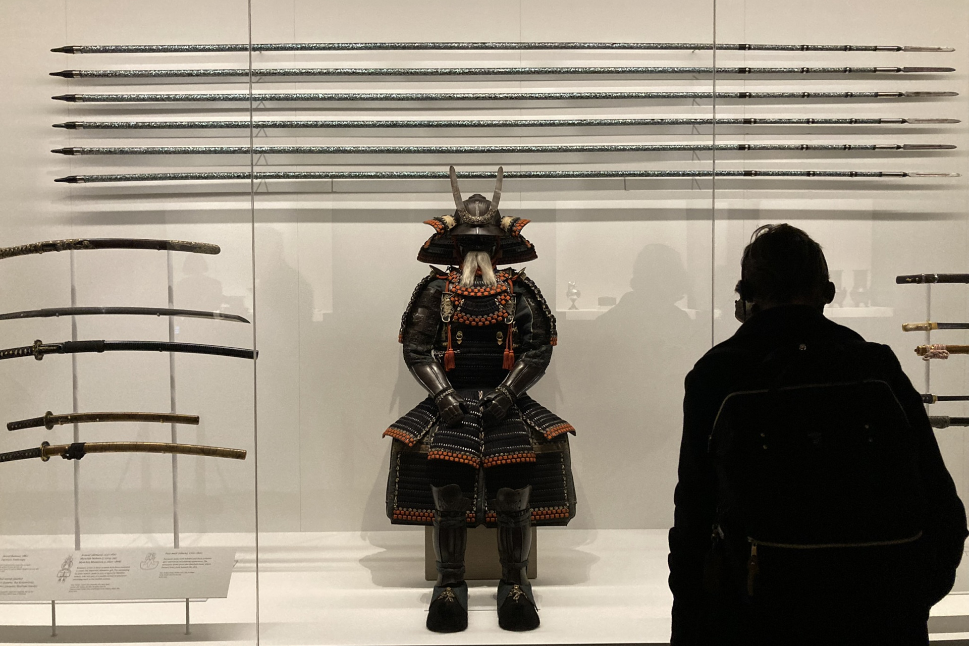 Someone viewing a samurai armour in a display case