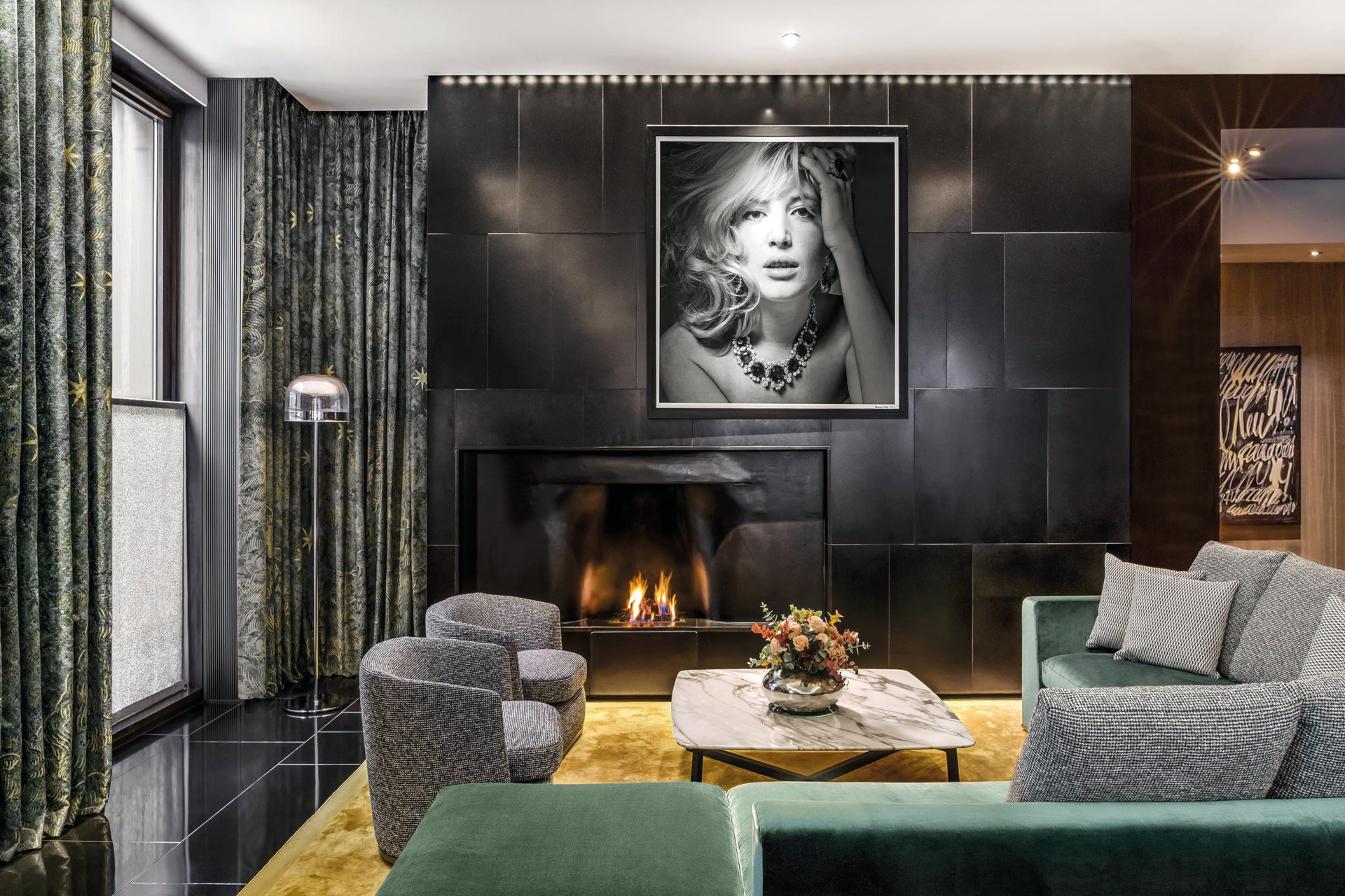 Sitting room with grey accents and black and white portrait on the wall
