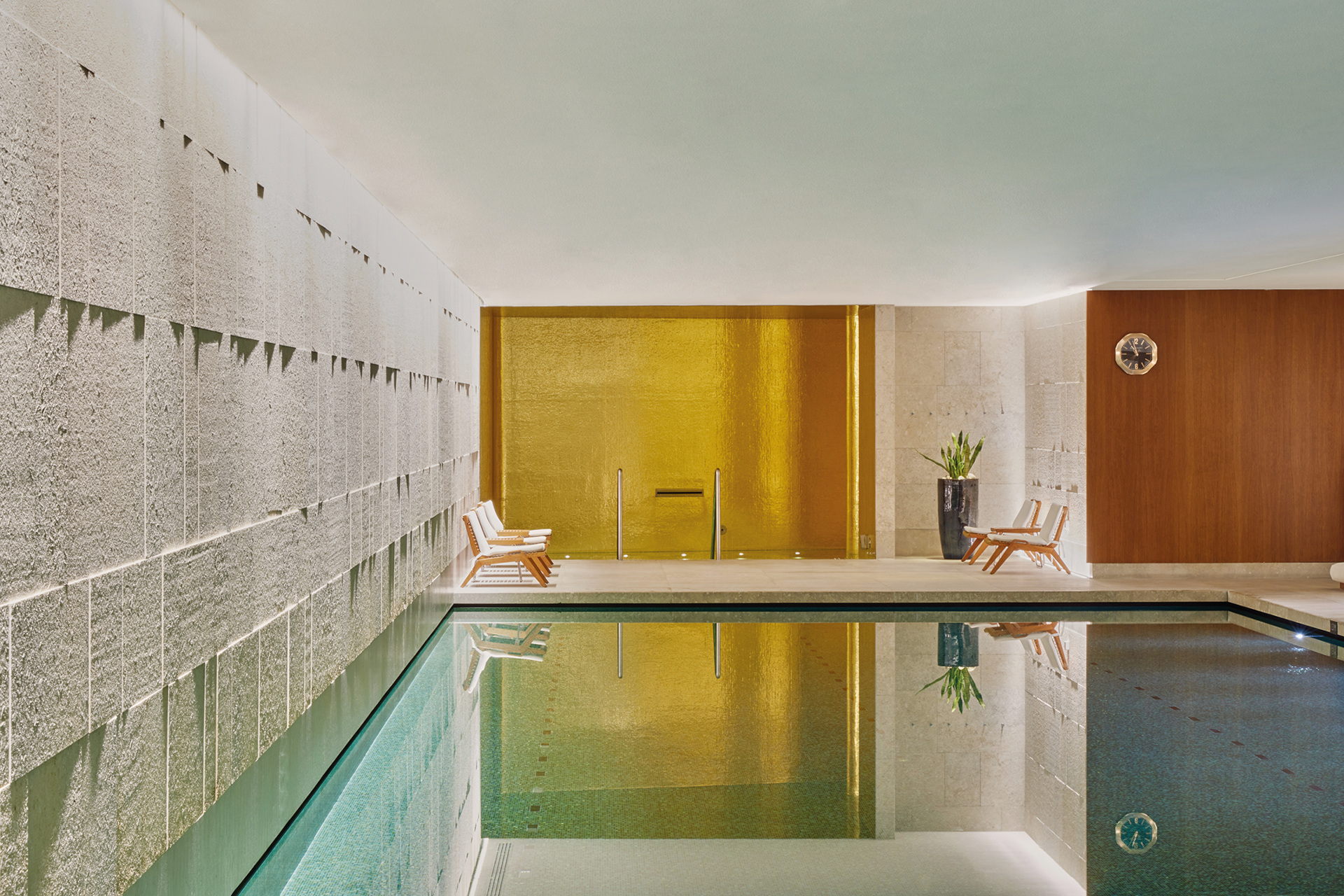 Indoor swimming pool with gold wall background