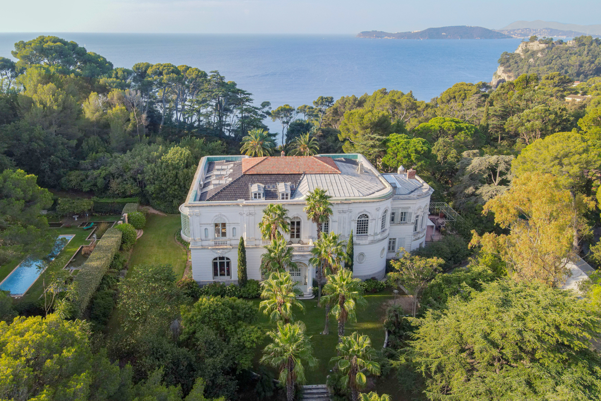 Aerial view over the mansion, gardens and water