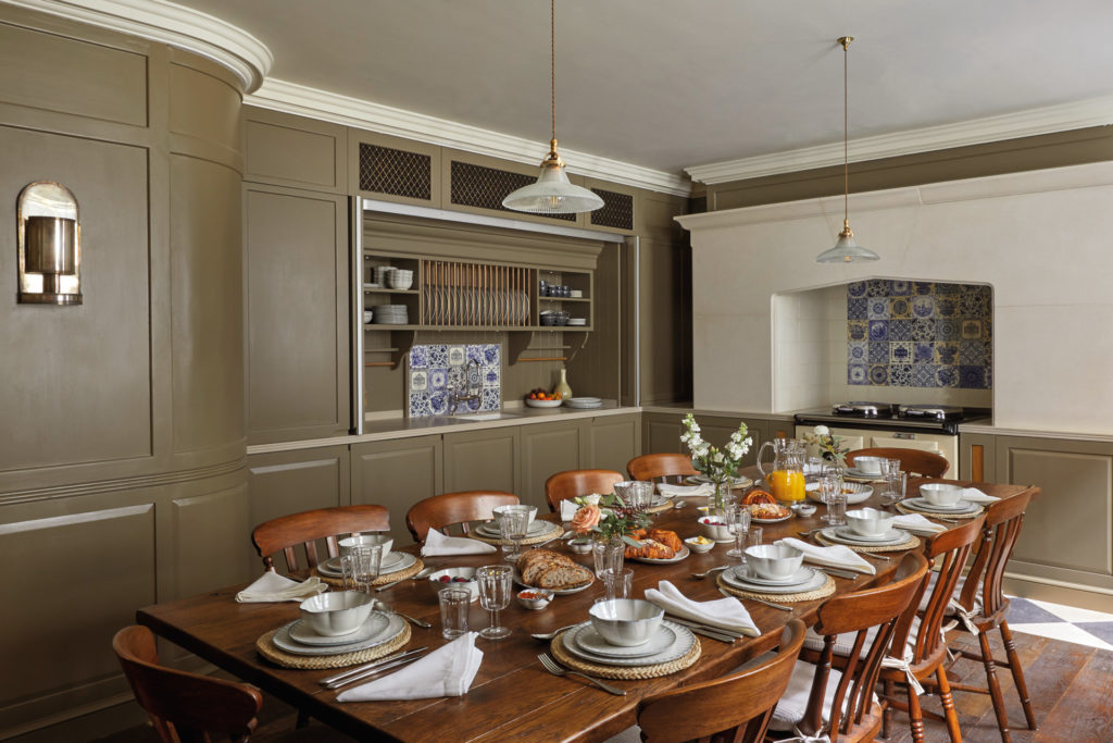 Dining room with long wooden table set for breakfast