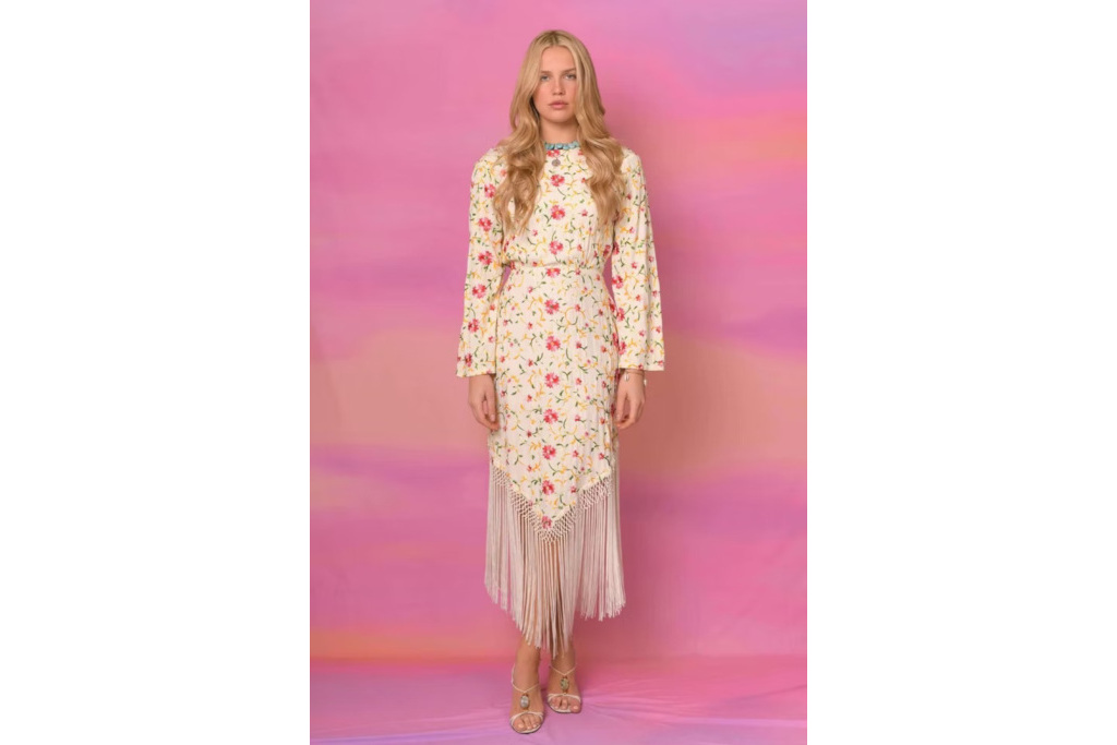 Model in floral fringe hem dress, on pink background
