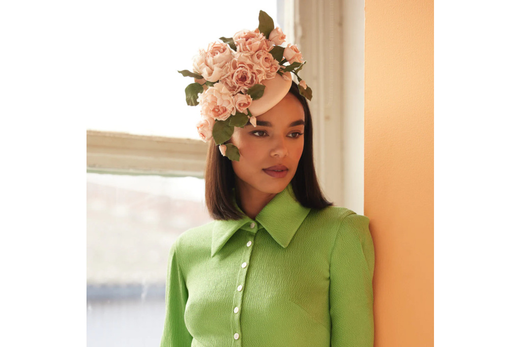 Woman in green jumper and ink floral headpiece