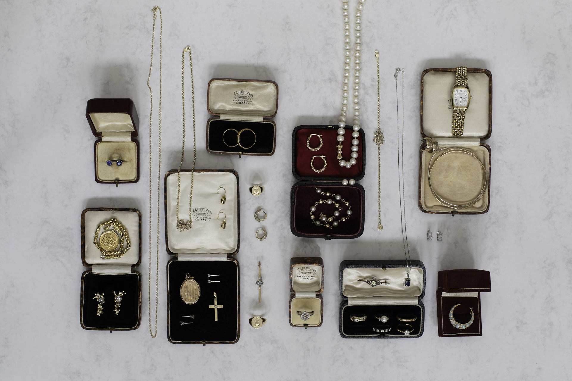 Boxes of jewellery laid out on table